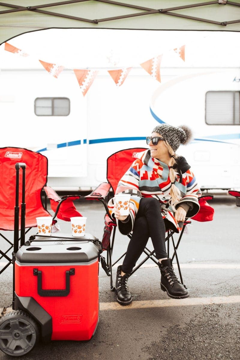 girl sitting at tailgate party 