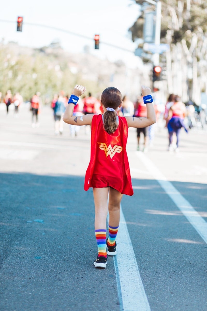 young girl running Wonder Woman race