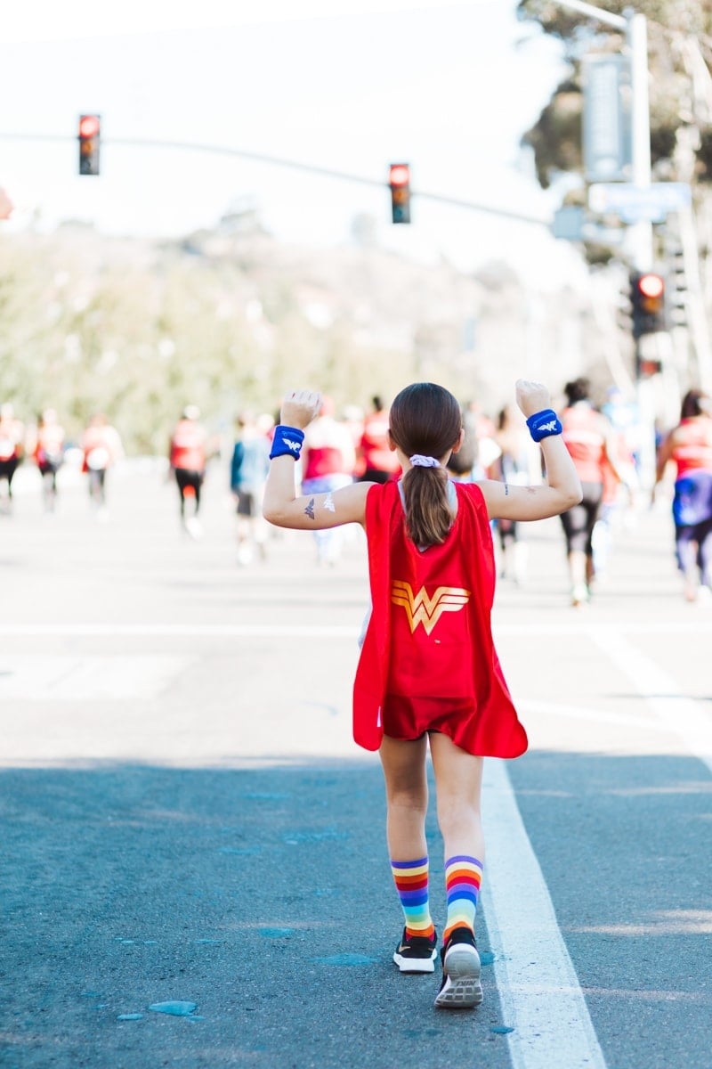 girl running wonder woman cape