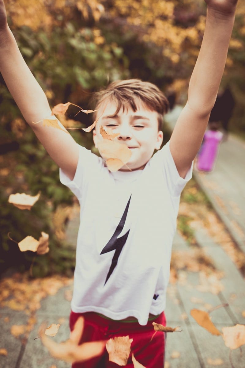 boy throwing leaves