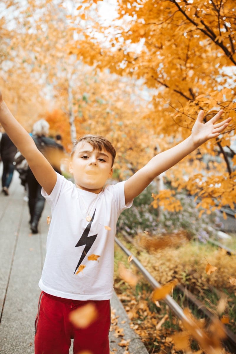 Boy throwing leaves