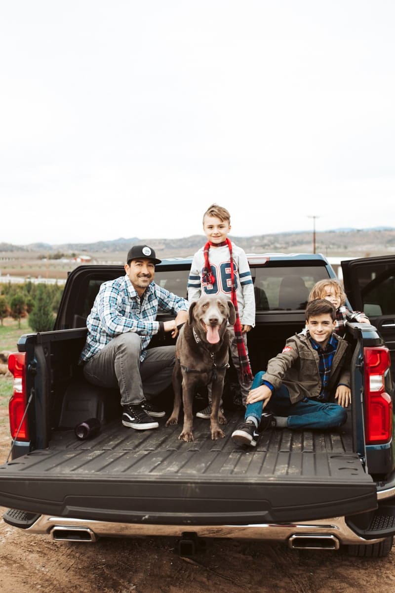 family and dog in the back of a truck