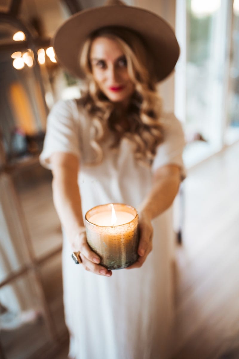 woman holding arhaus candle