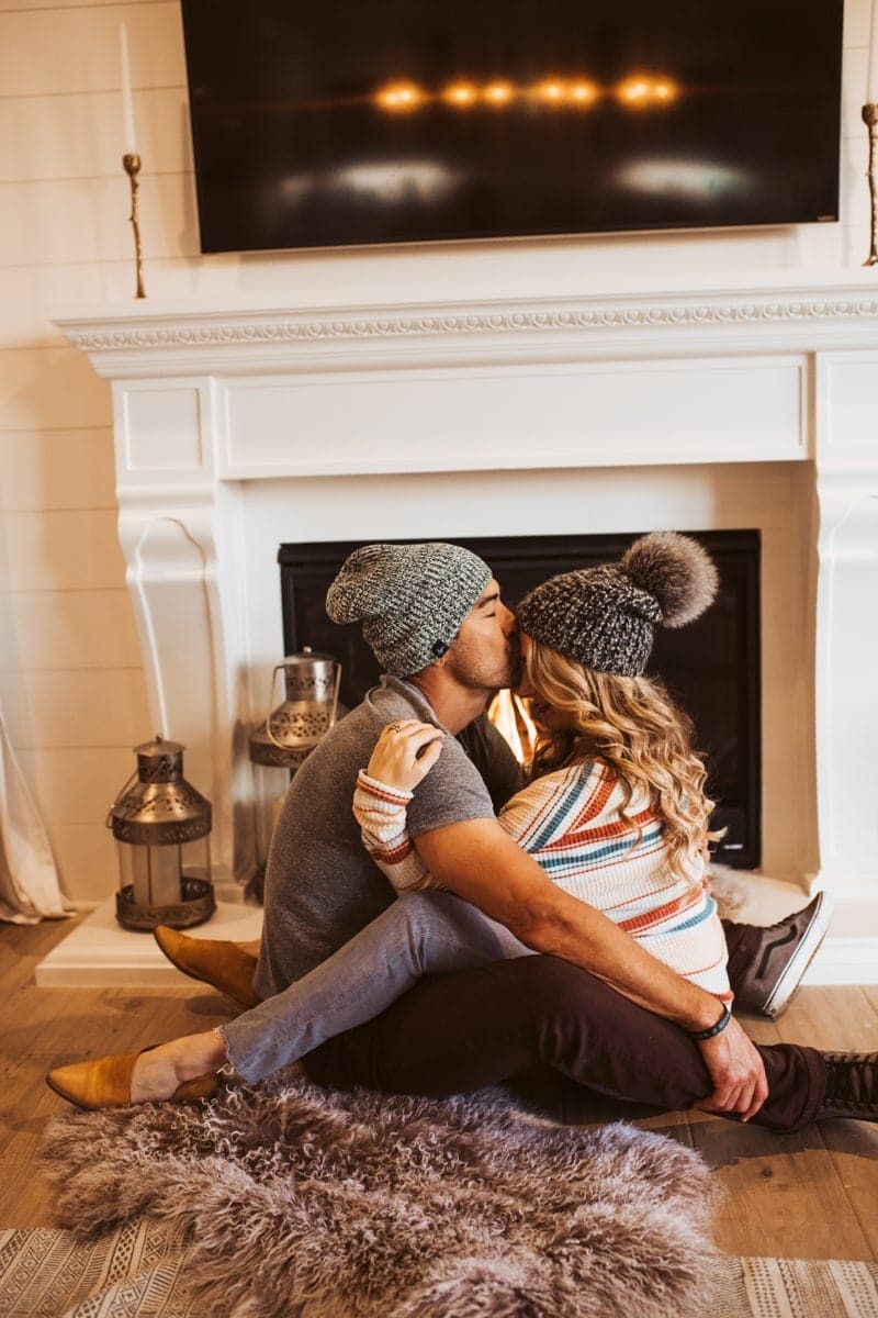 couple kissing by fire