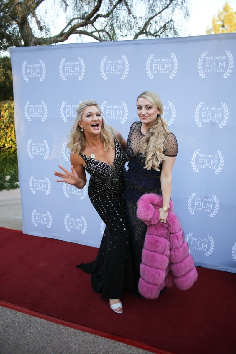 women posing on red carpet