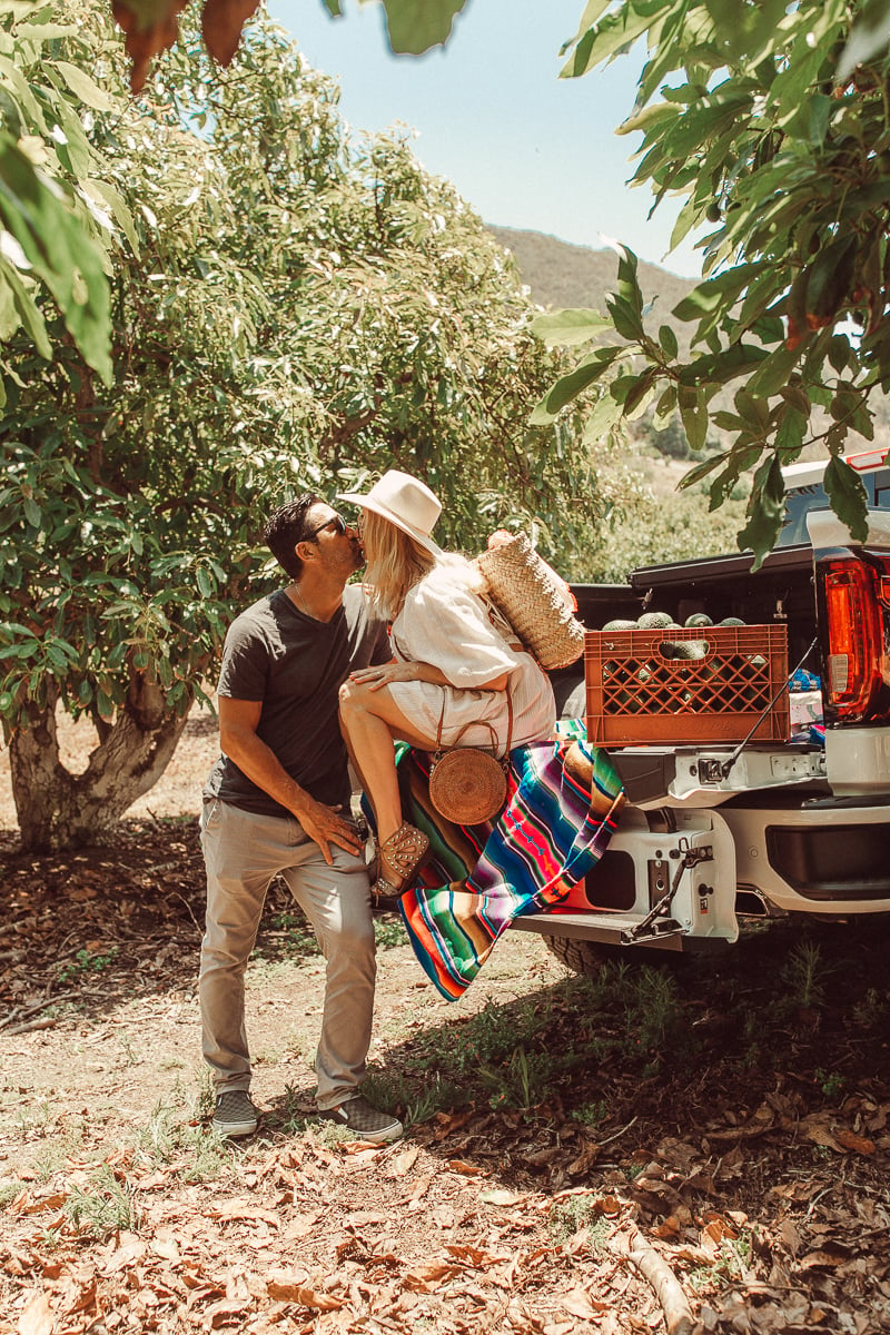 couple kissing in orchard 