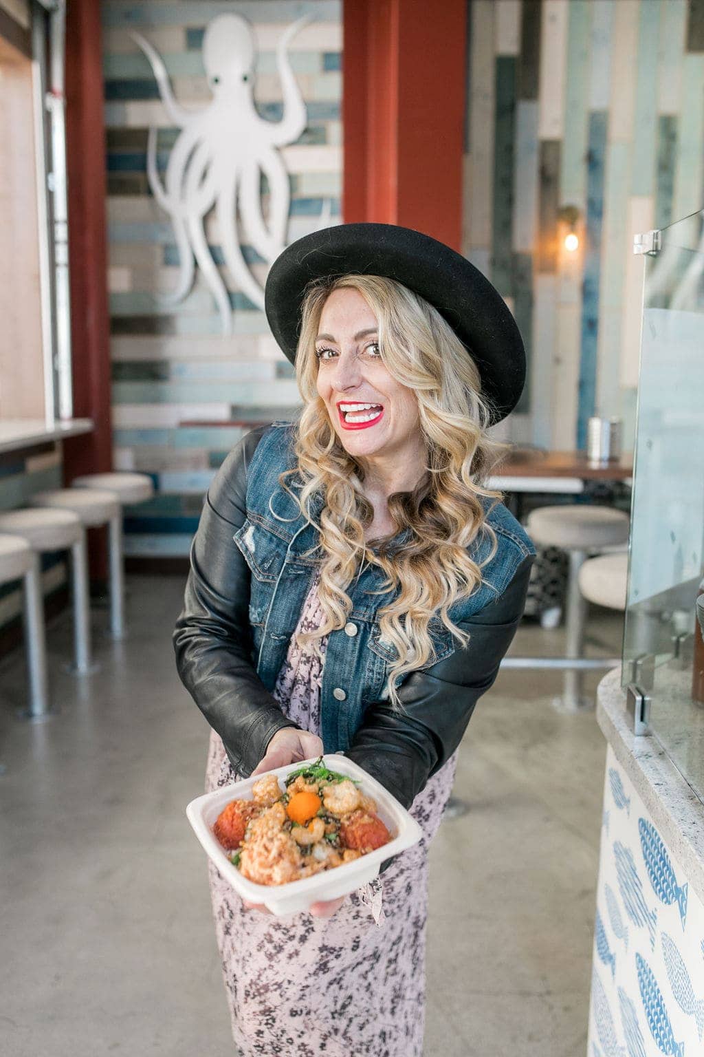 woman holding poke bowl