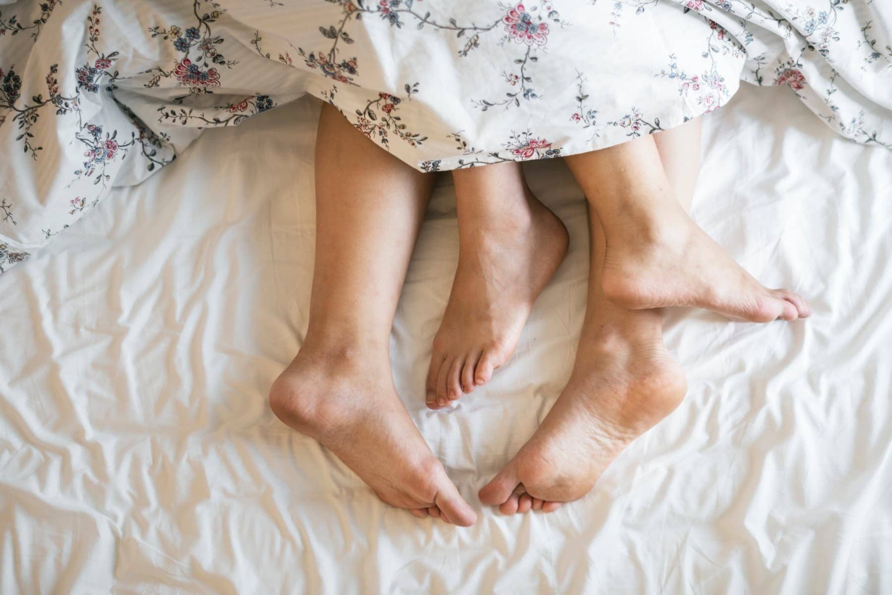 couple in bed with feet sticking out