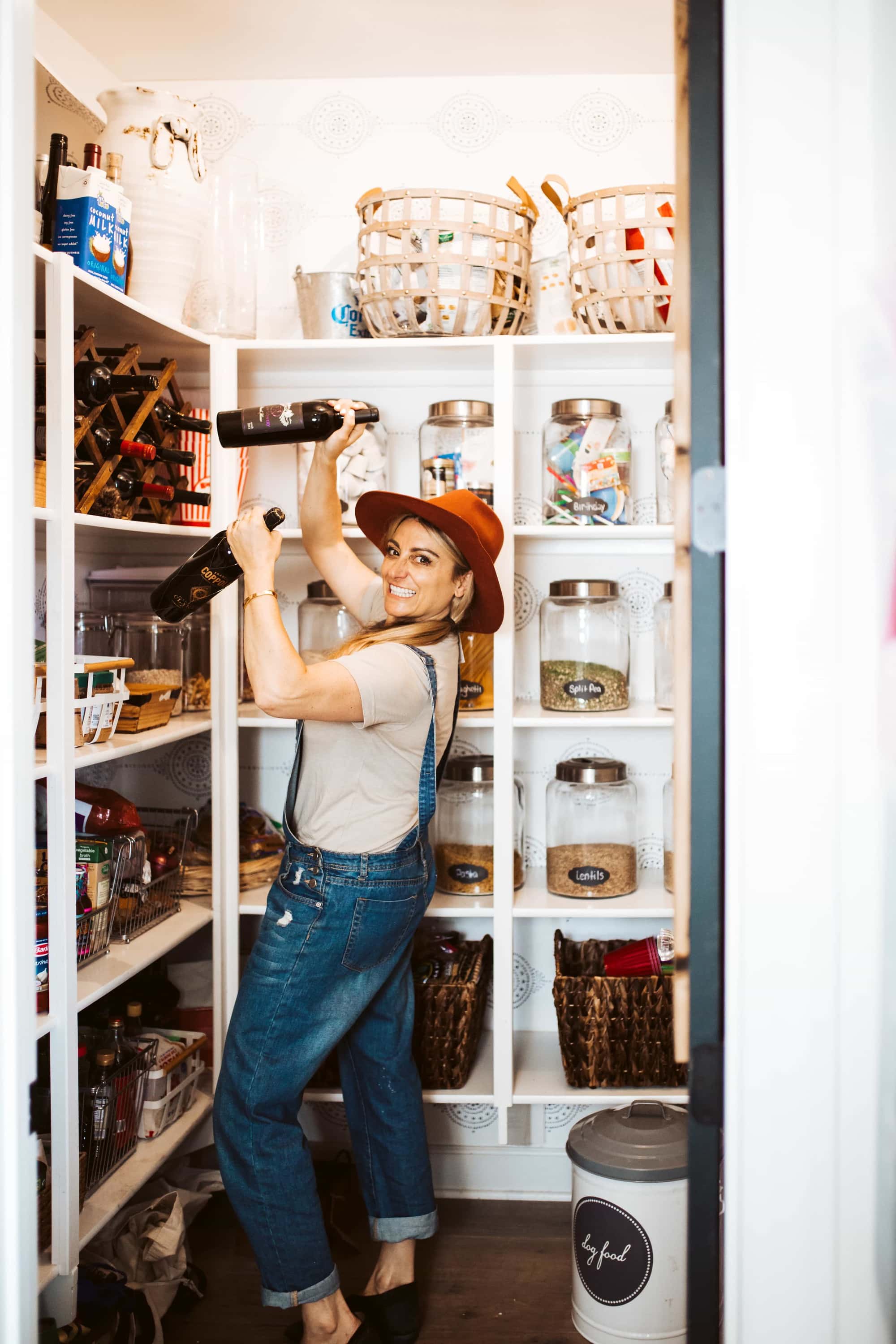 woman getting wine from pantry