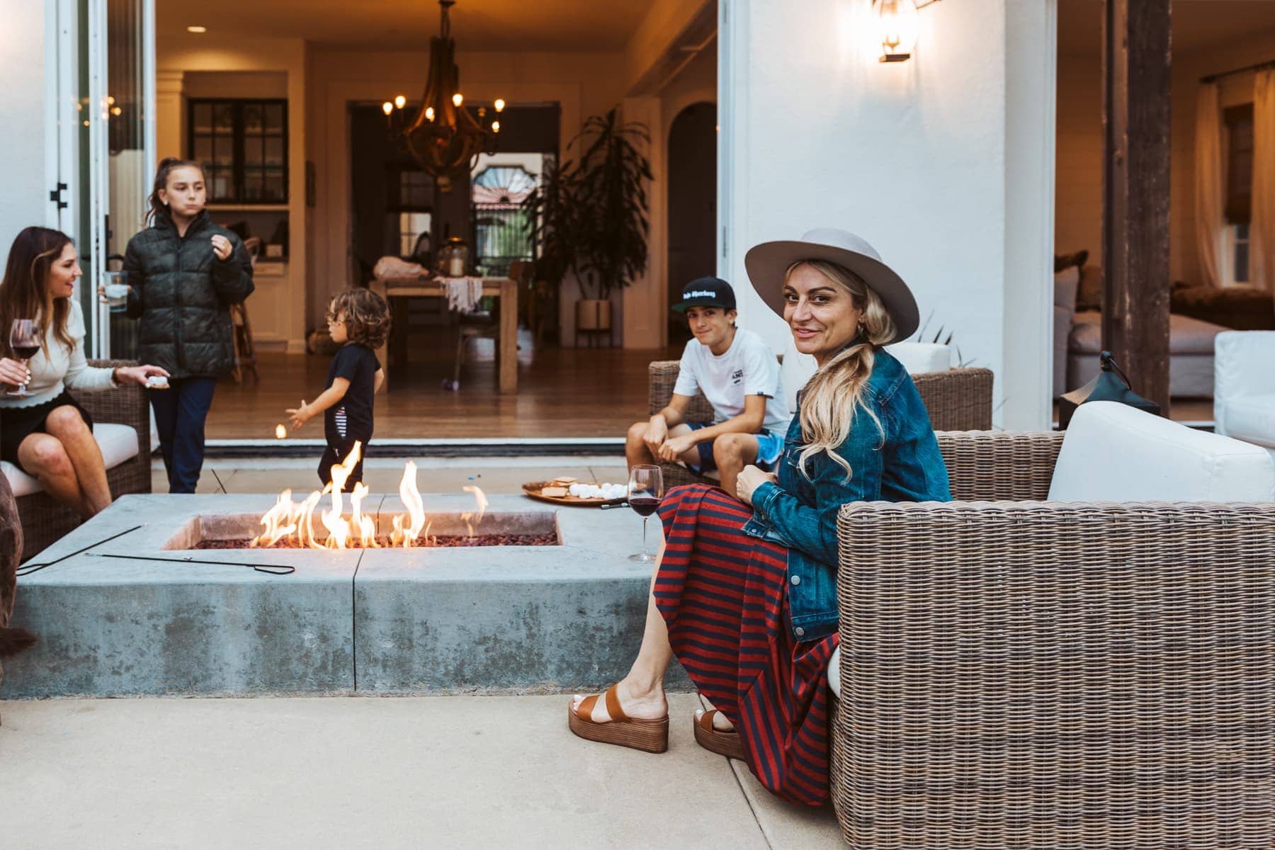 family in backyard around firepit