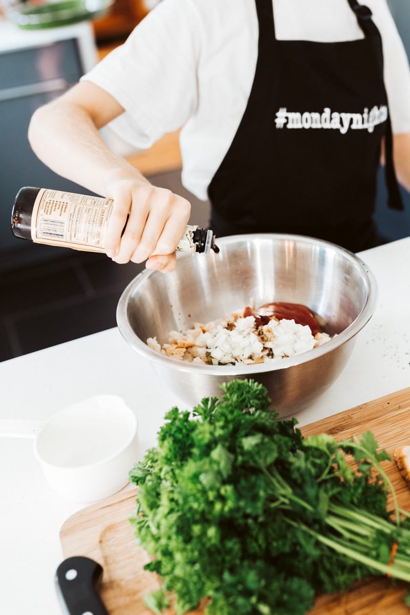 adding ingredients to a mixing bowl