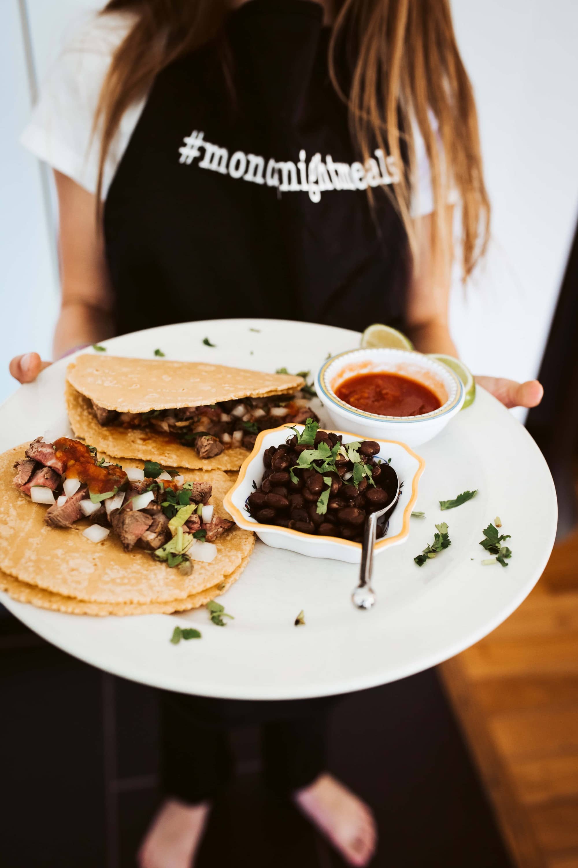 girl holding taco plate