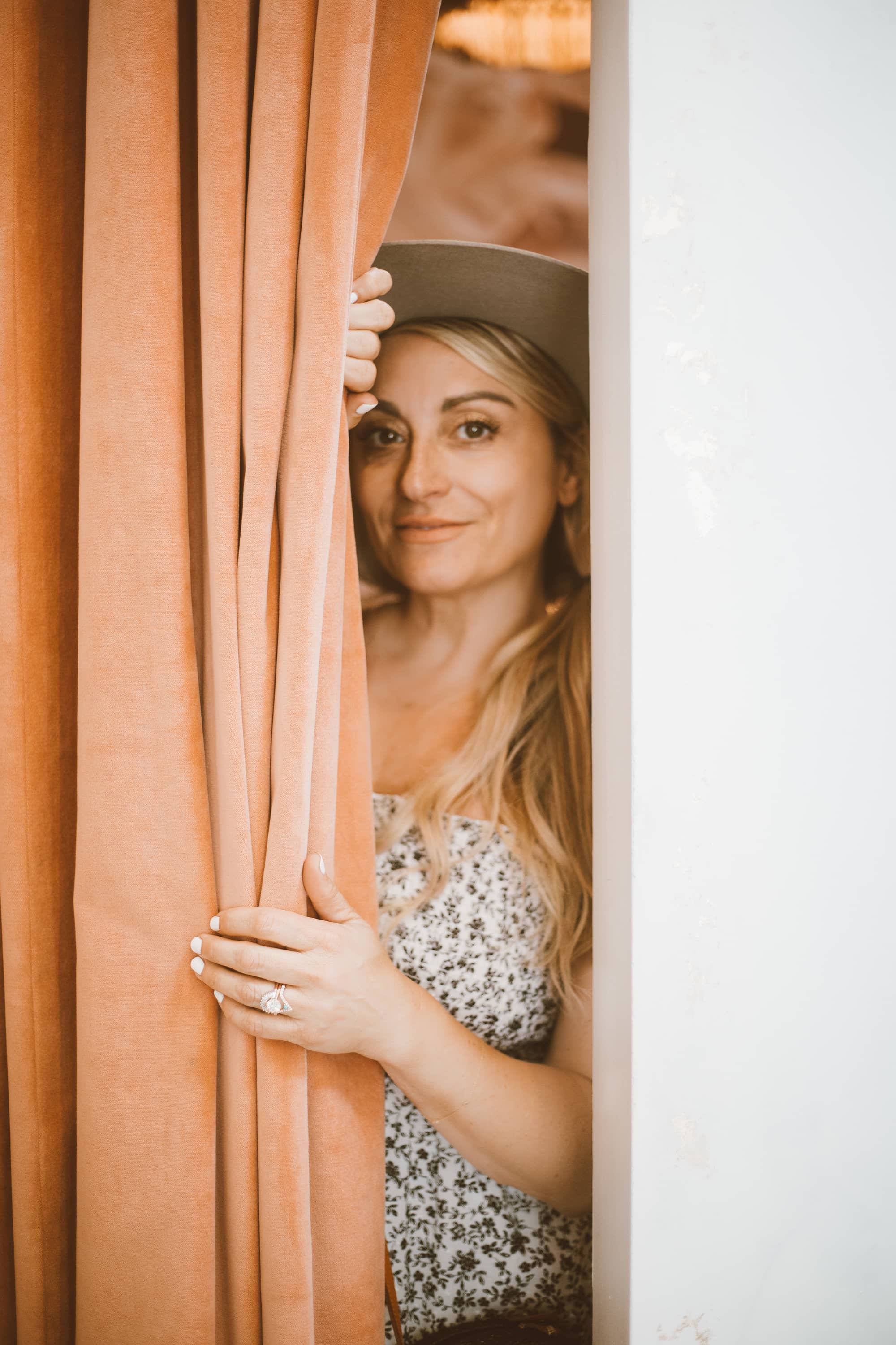 woman behind curtain