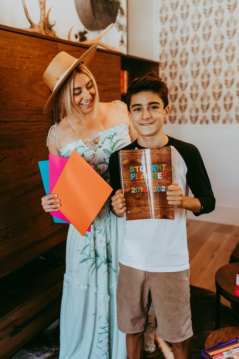 mom and son holding school planner