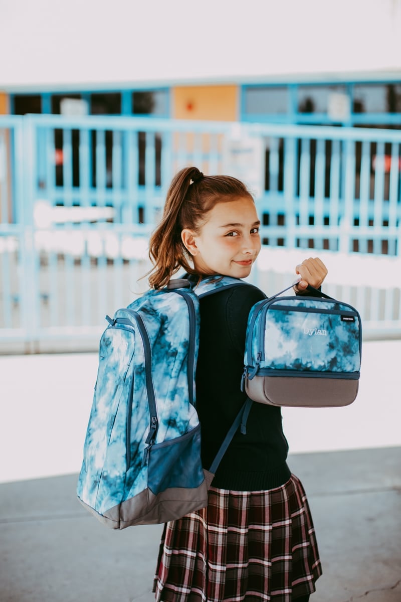 school girl with backpack and lunch