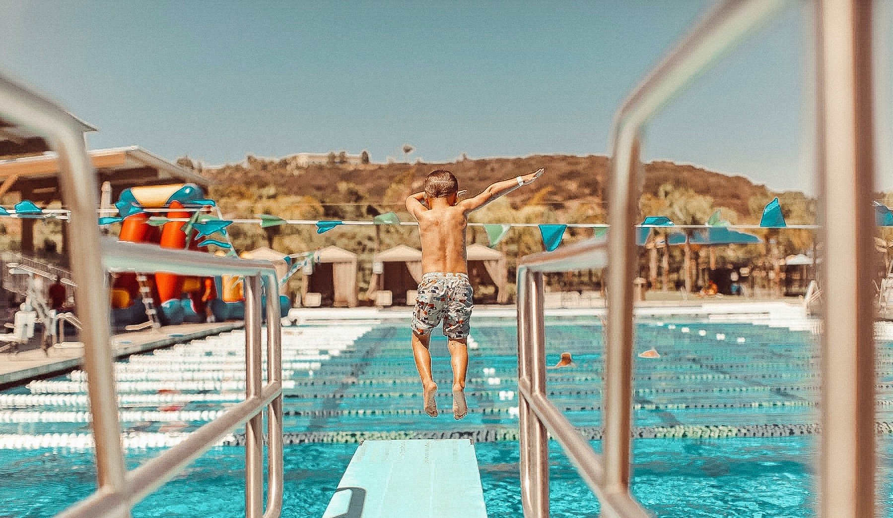 boy jumping in the pool