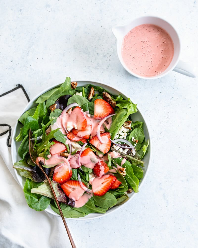 Colorful strawberries, sliced red onion, chopped nuts and crumbled feta cheese come together for a delicious summer favorite.