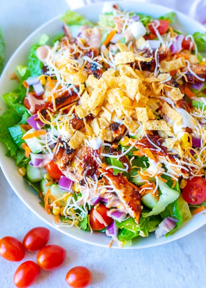 A BBQ Chicken Salad packed with all the goods—cheese, chips, sweet corn, and tangy barbecue sauce. One of the best salads kids love.