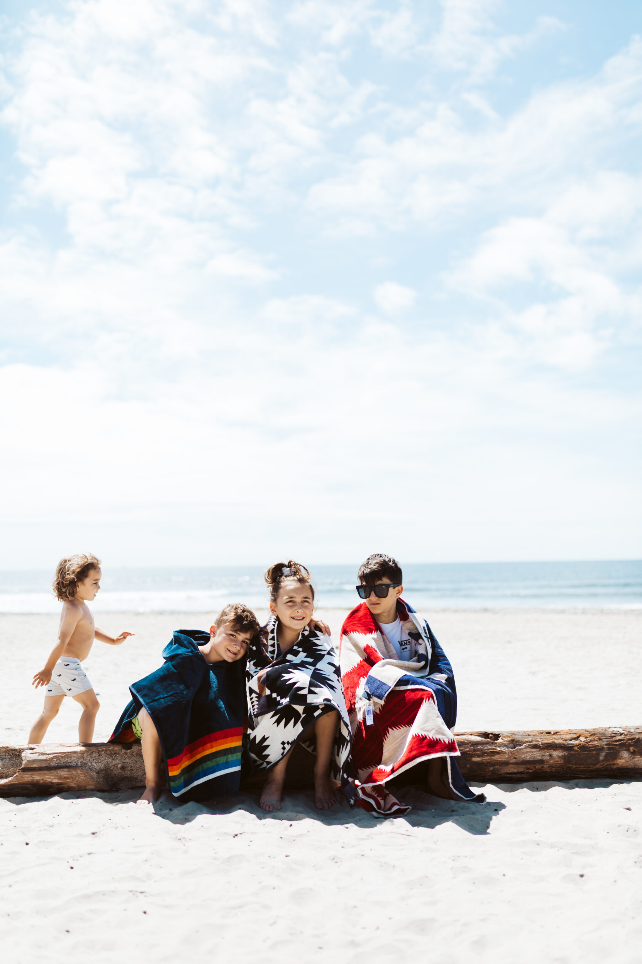 kids sitting on the beach