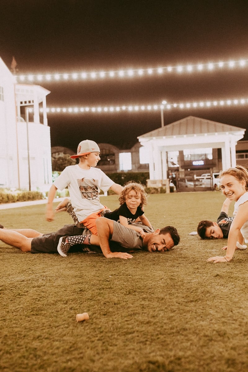 family playing outside at night