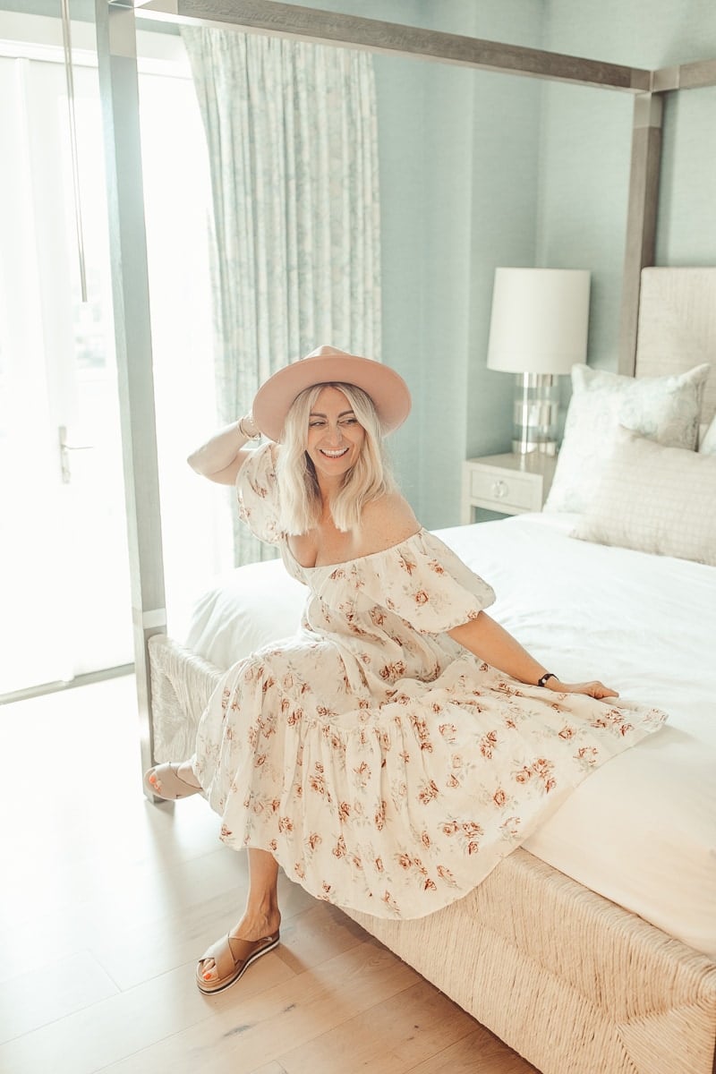 happy woman sitting on bed