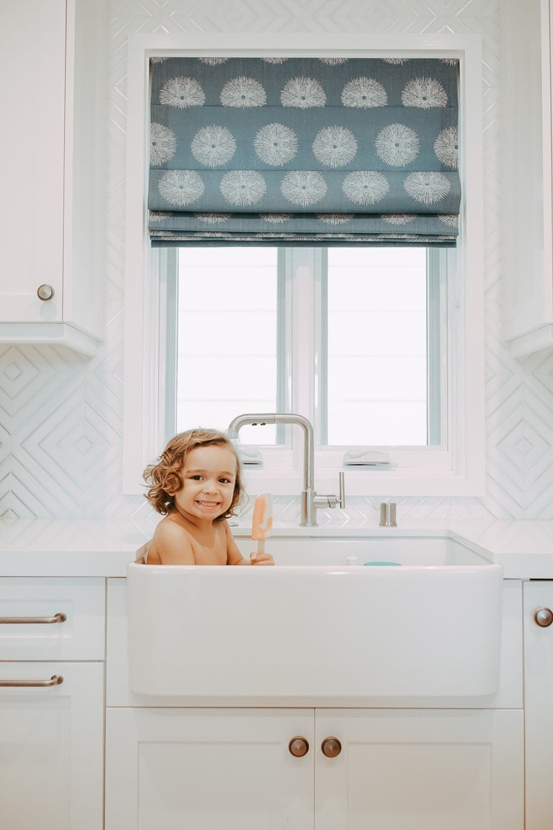 baby in kitchen sink