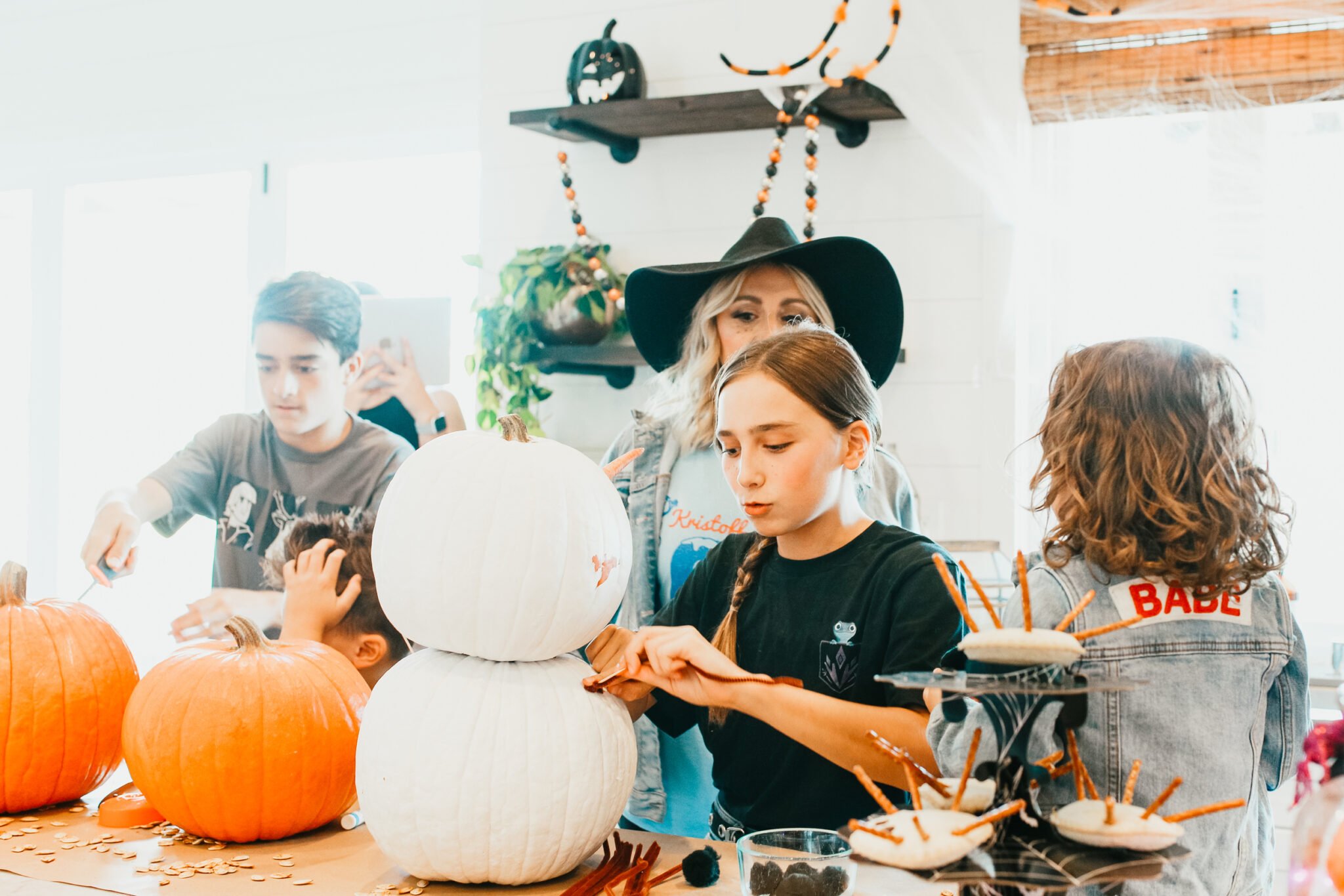 family decorating pumpkins