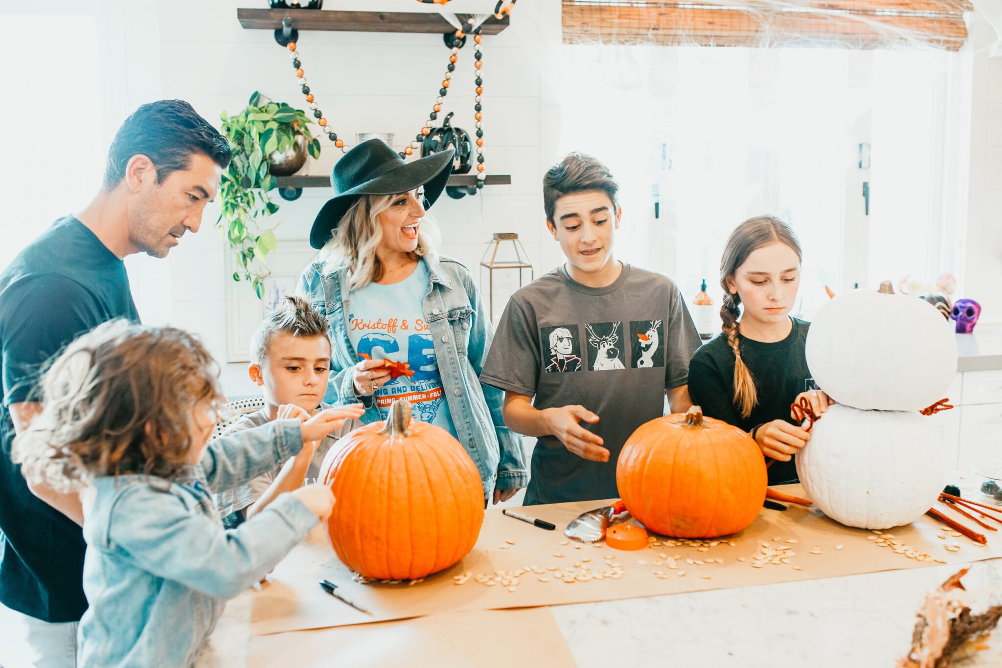 family carving pumpkins