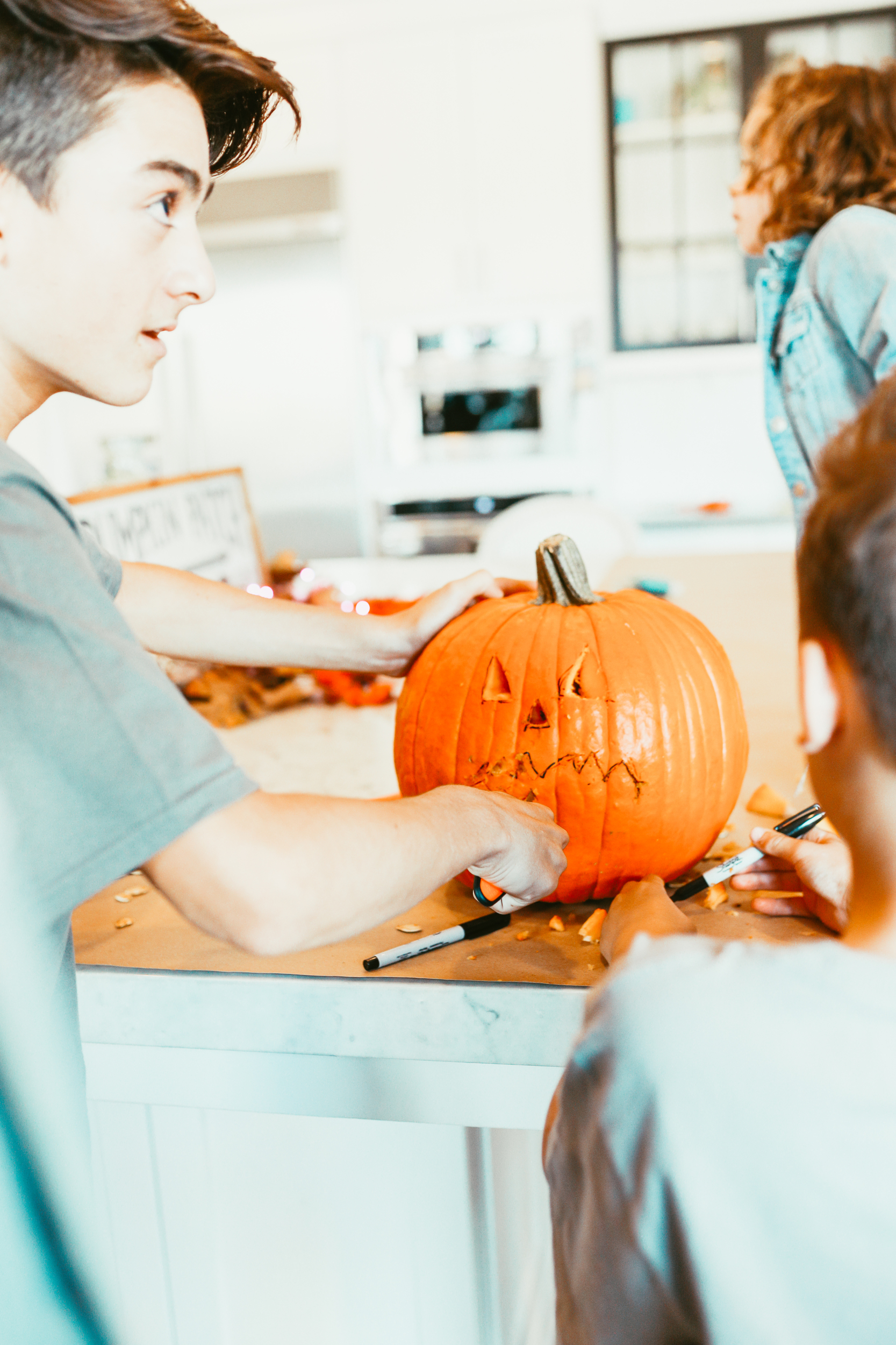 boy carving a pumpkin