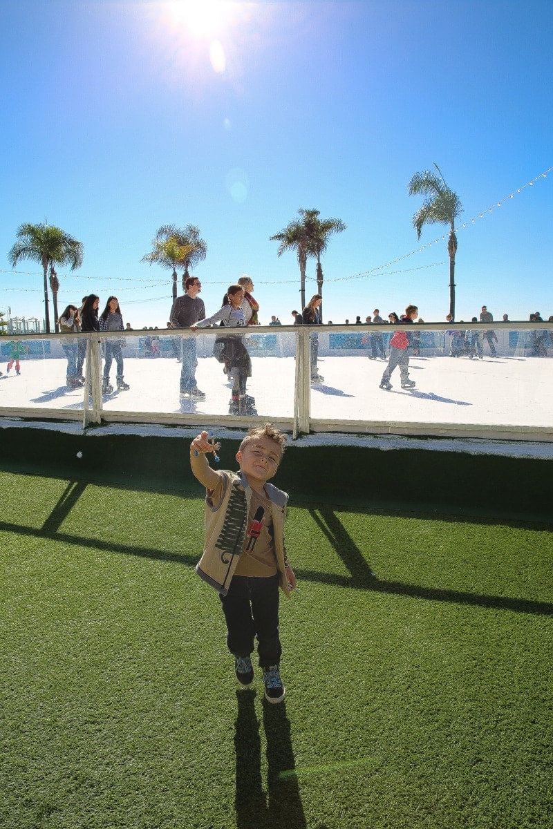 child by ice skating rink