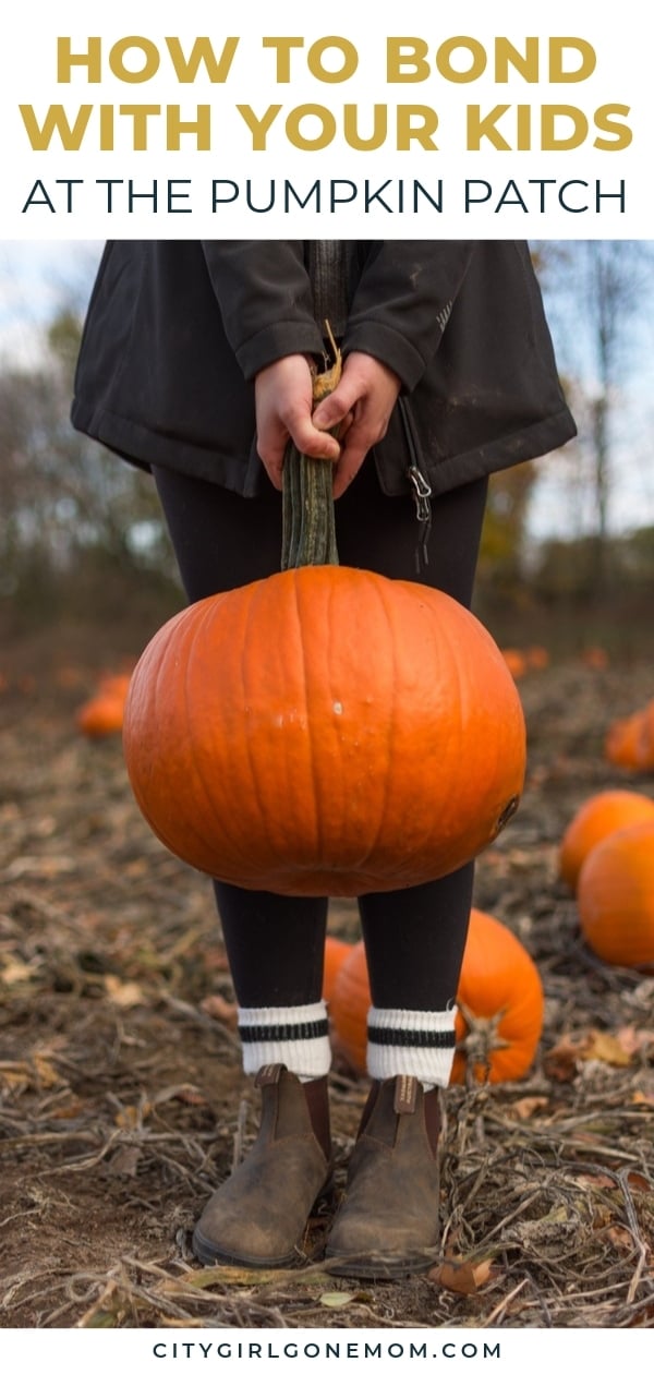 kid holding a pumpkin