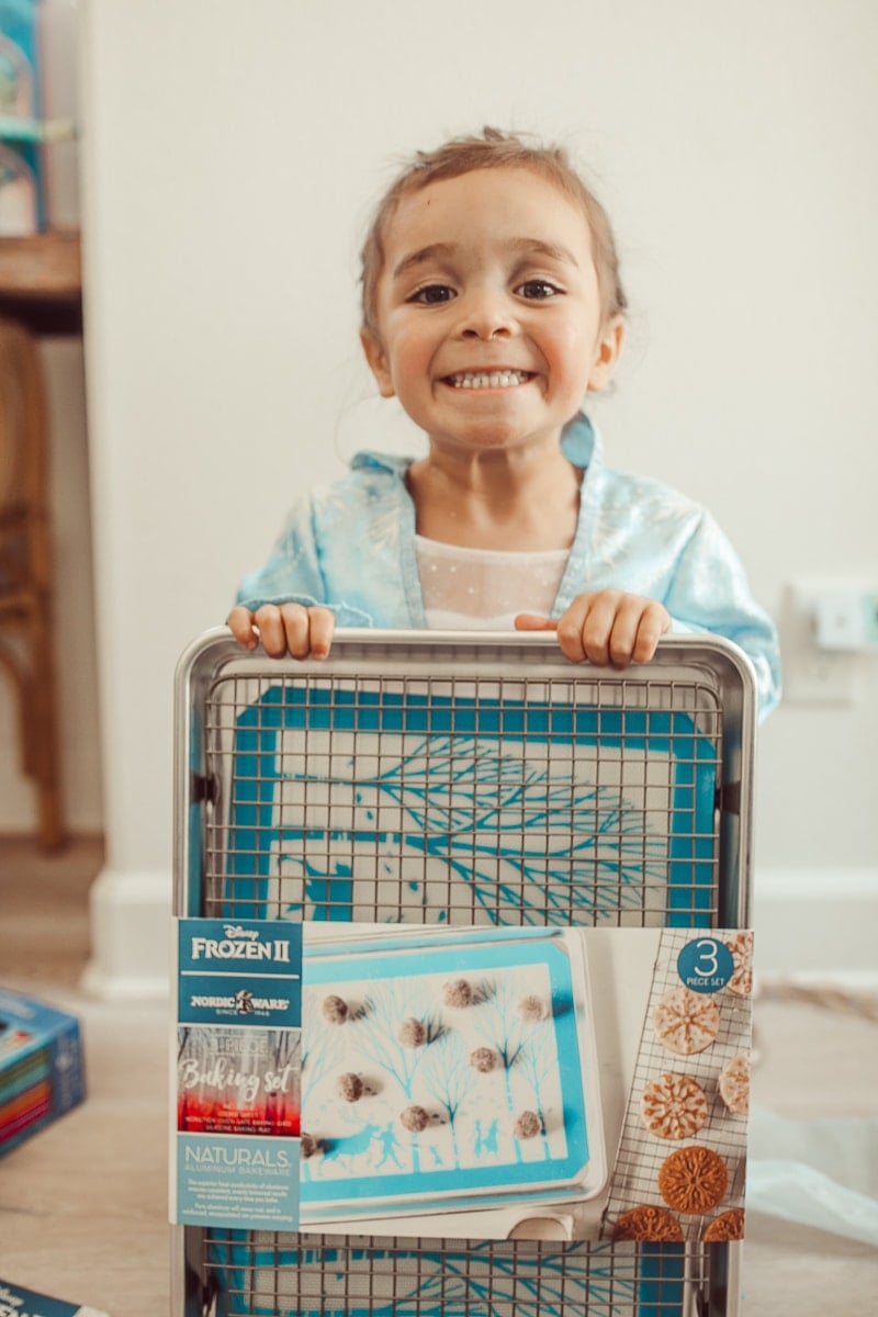 toddler with disney frozen baking sheet