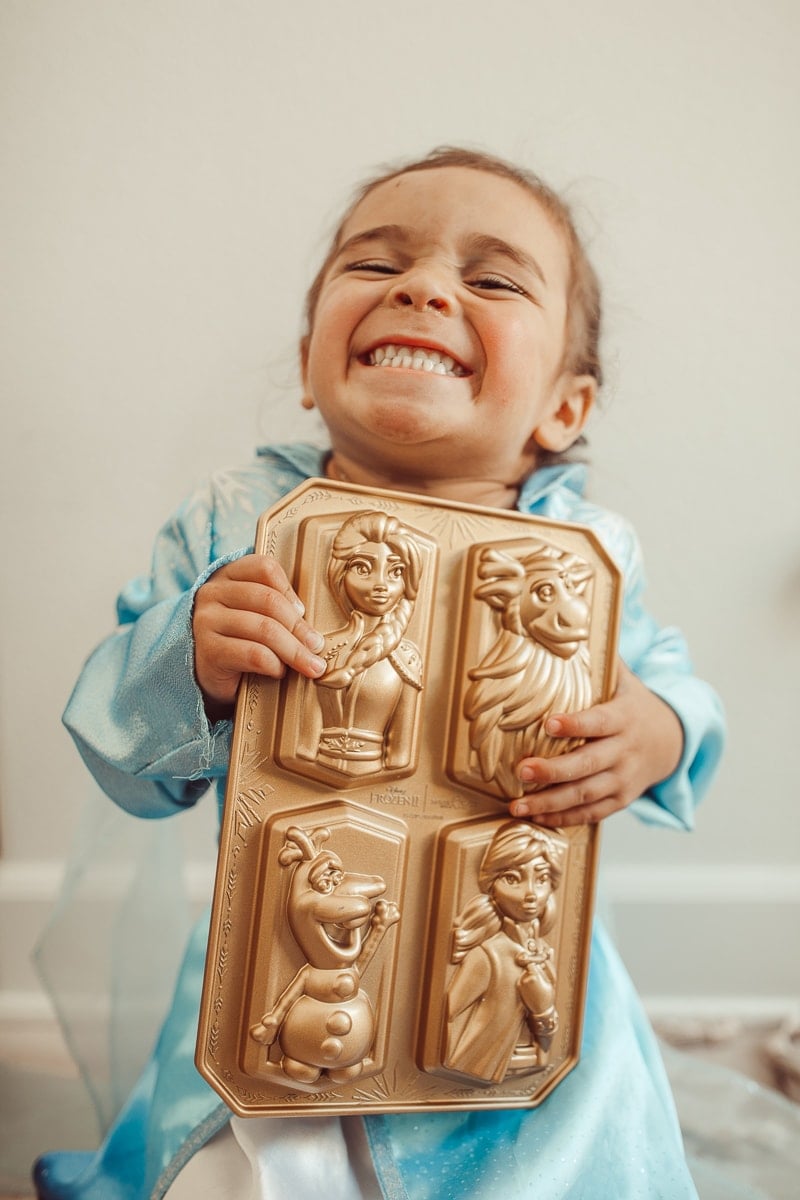 happy toddler with baking pans frozen 