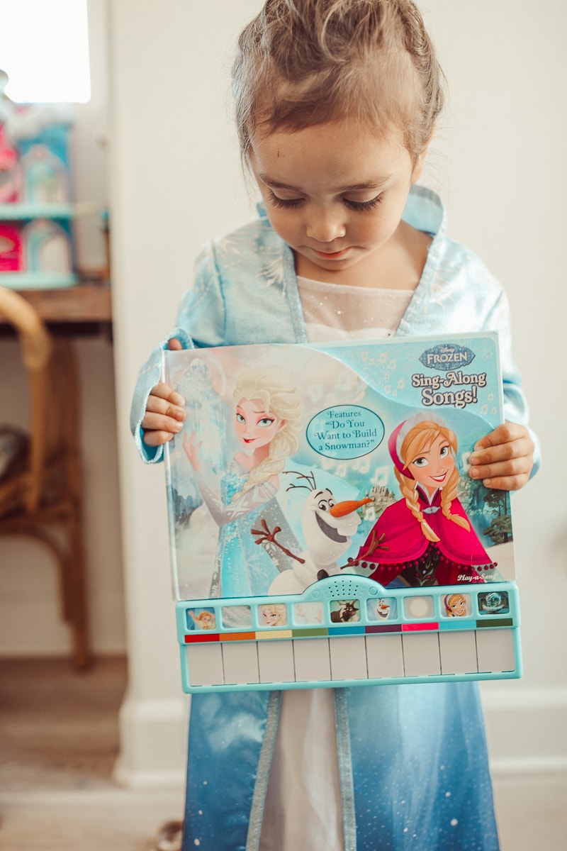 toddler with disney frozen toy