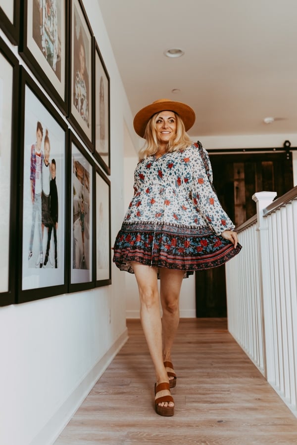 woman in dress and hat in hallway