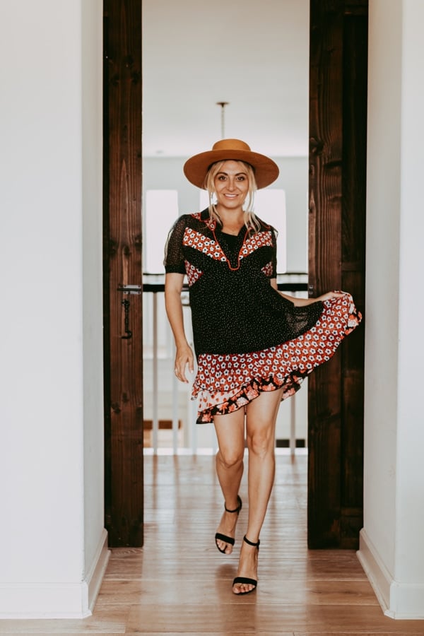 woman in dress and hat in doorway