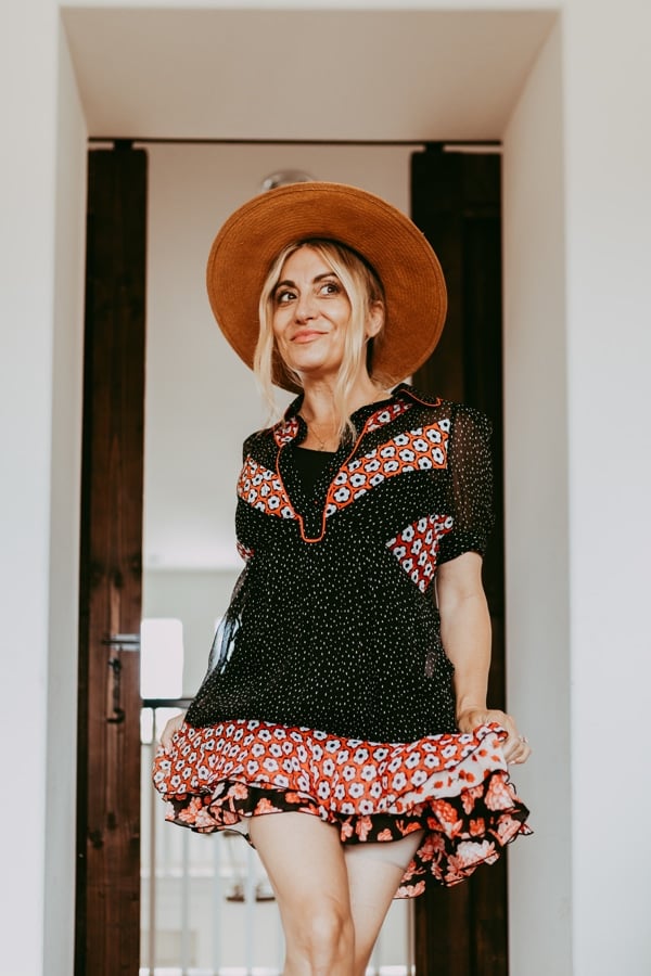 woman walking in dress and hat