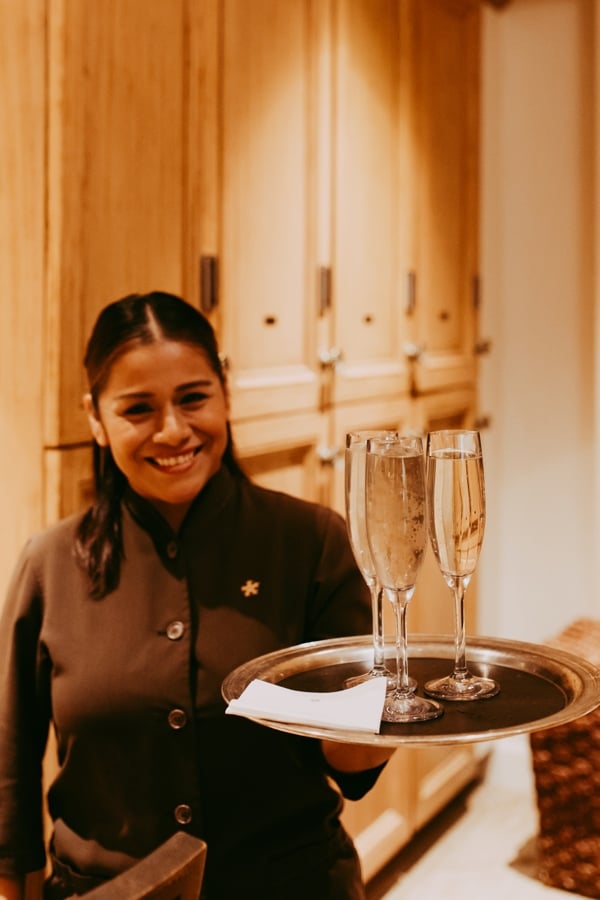woman serving champagne