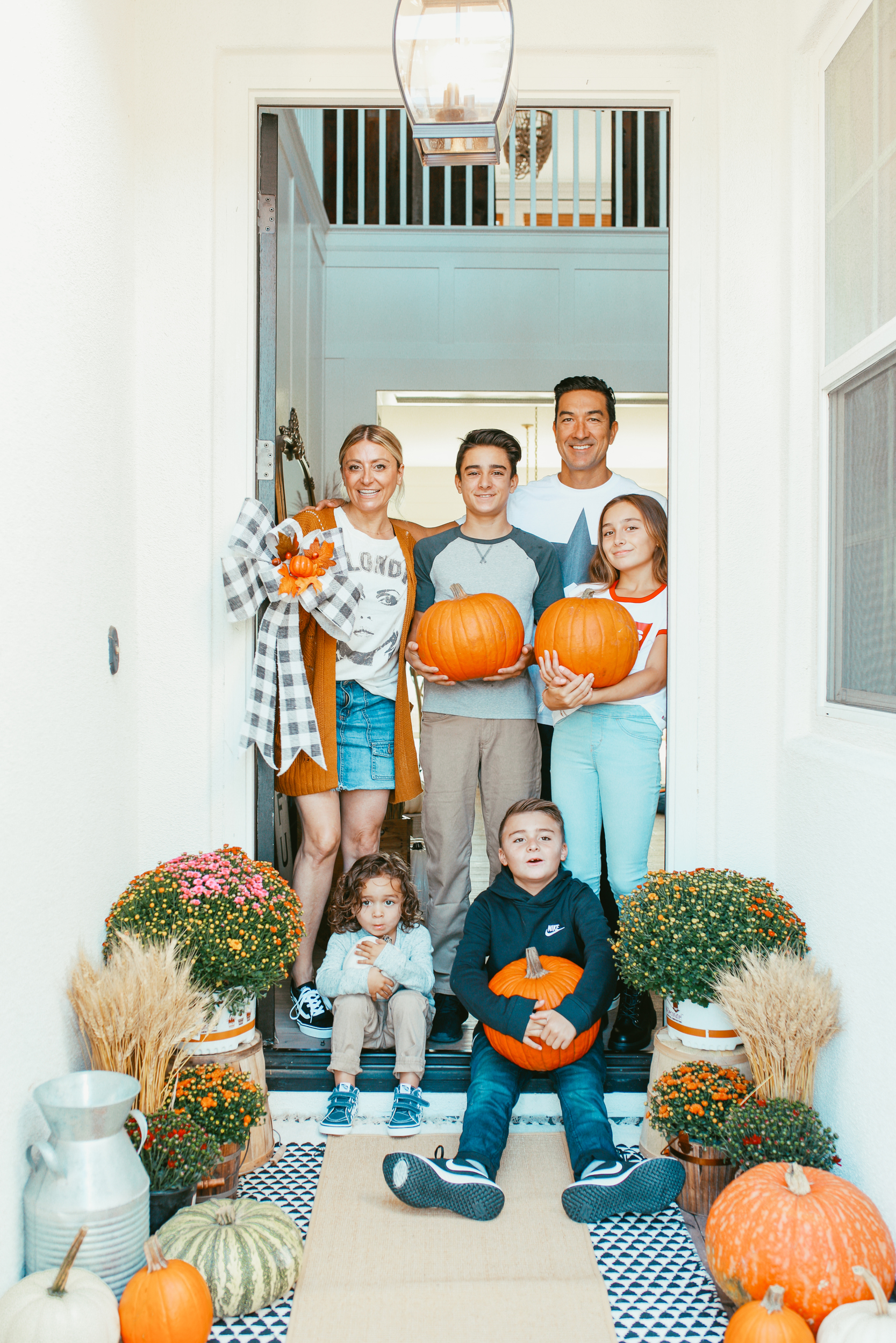 family holding pumpkins