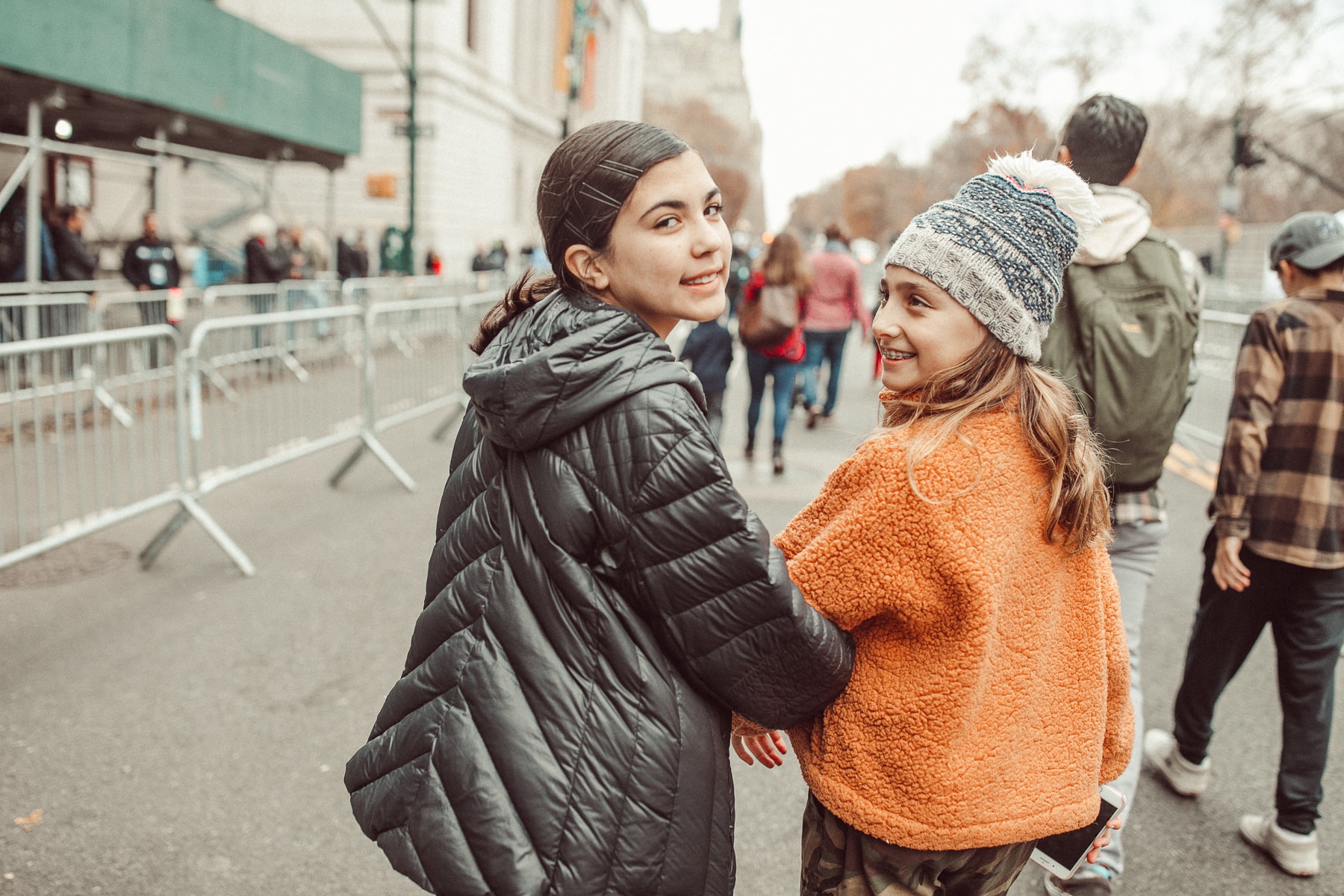 two girls walking down the street