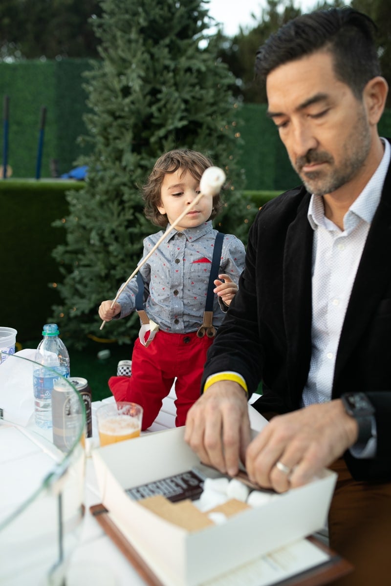 father and son making smores