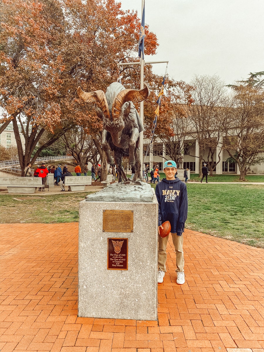 boy standing by statue