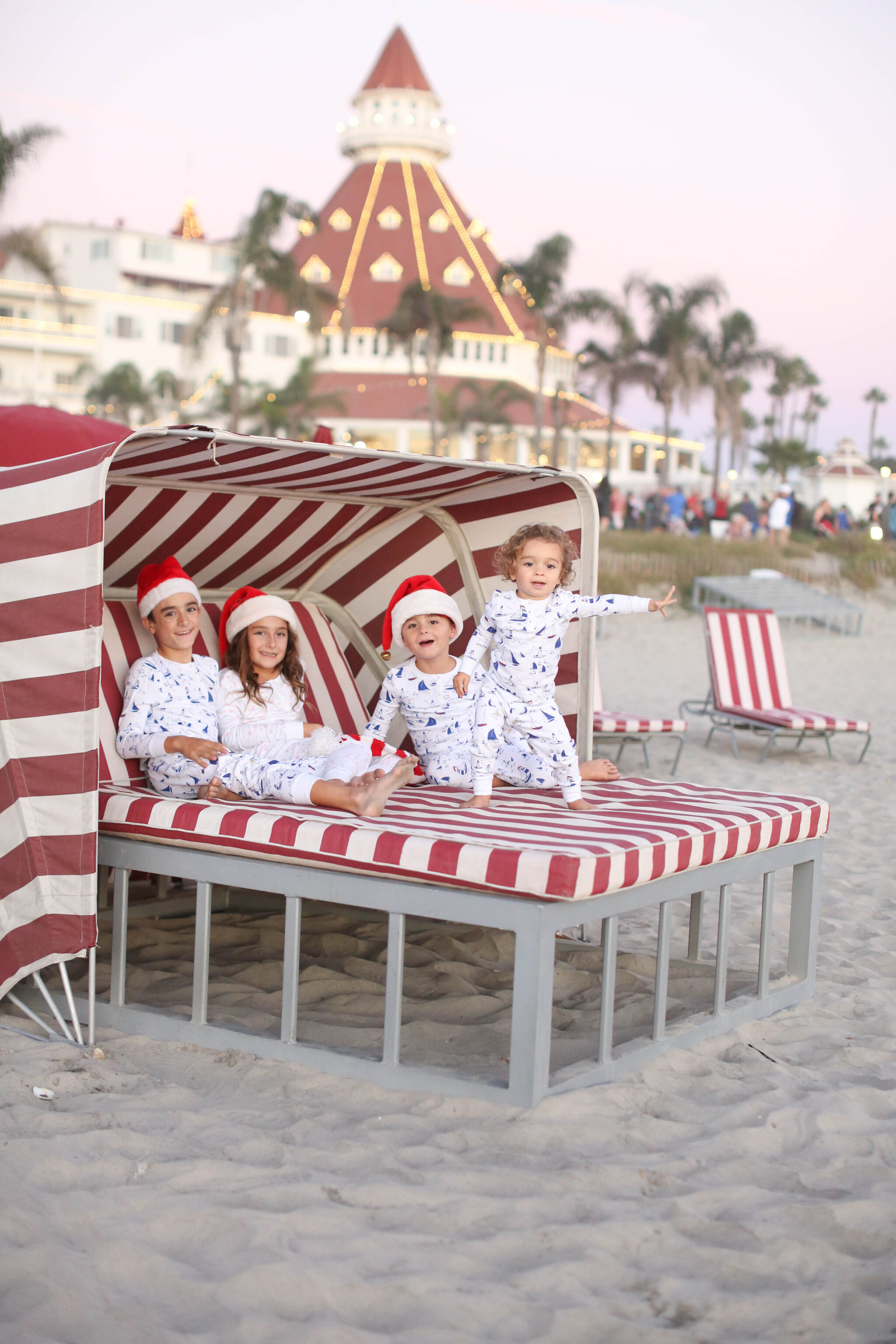 kids in santa hats on the beach