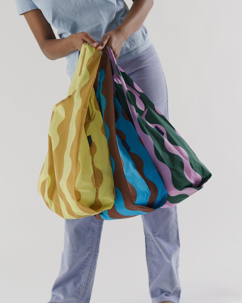 woman holding three bags