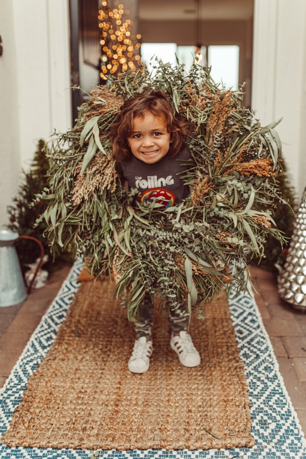 toddler in christmas wreath