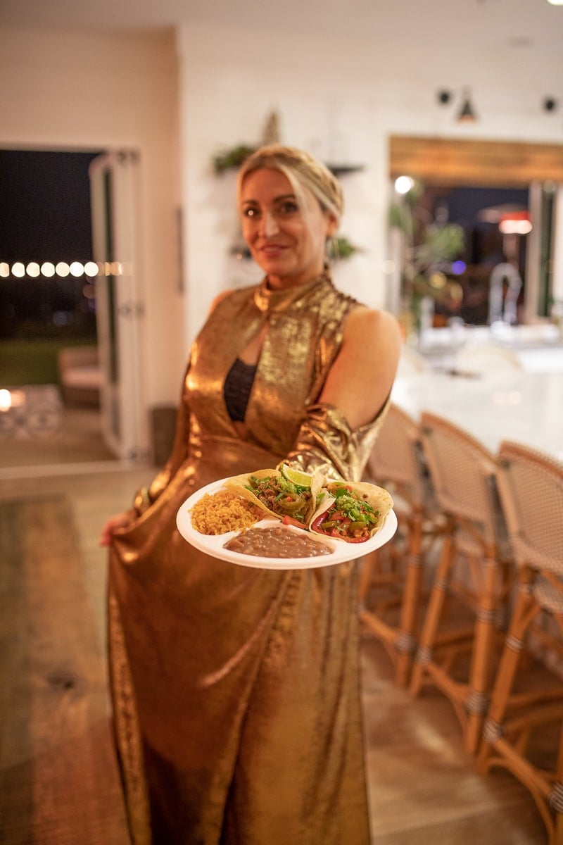 woman holding taco plate