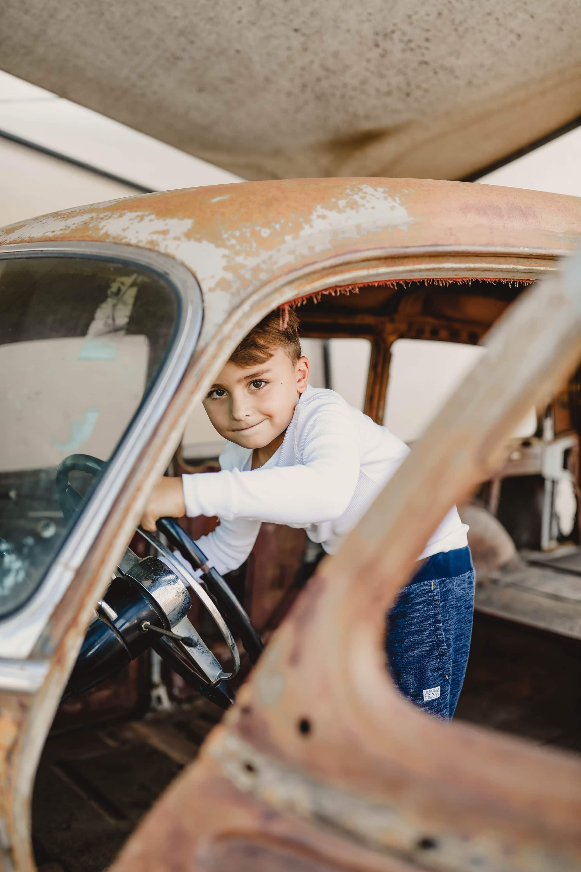 boy in old car