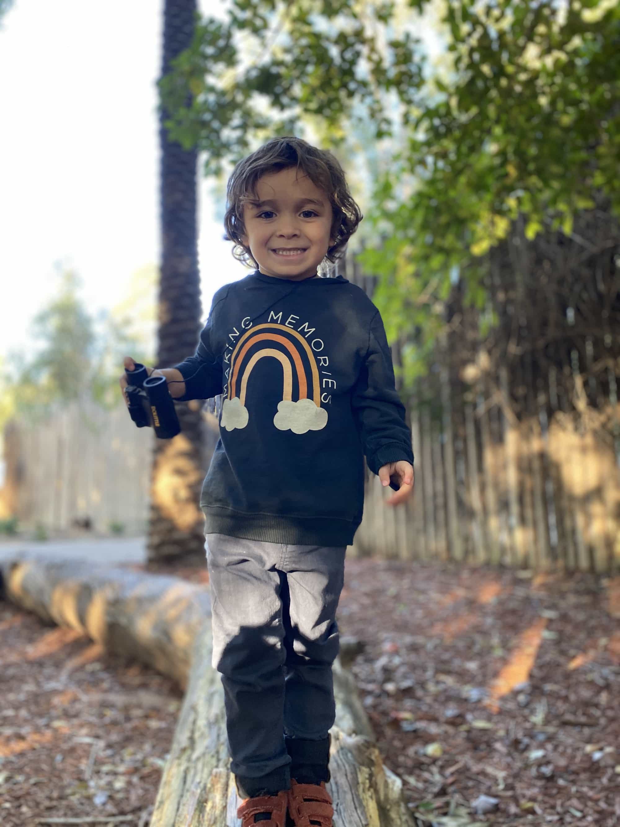 boy walking through park