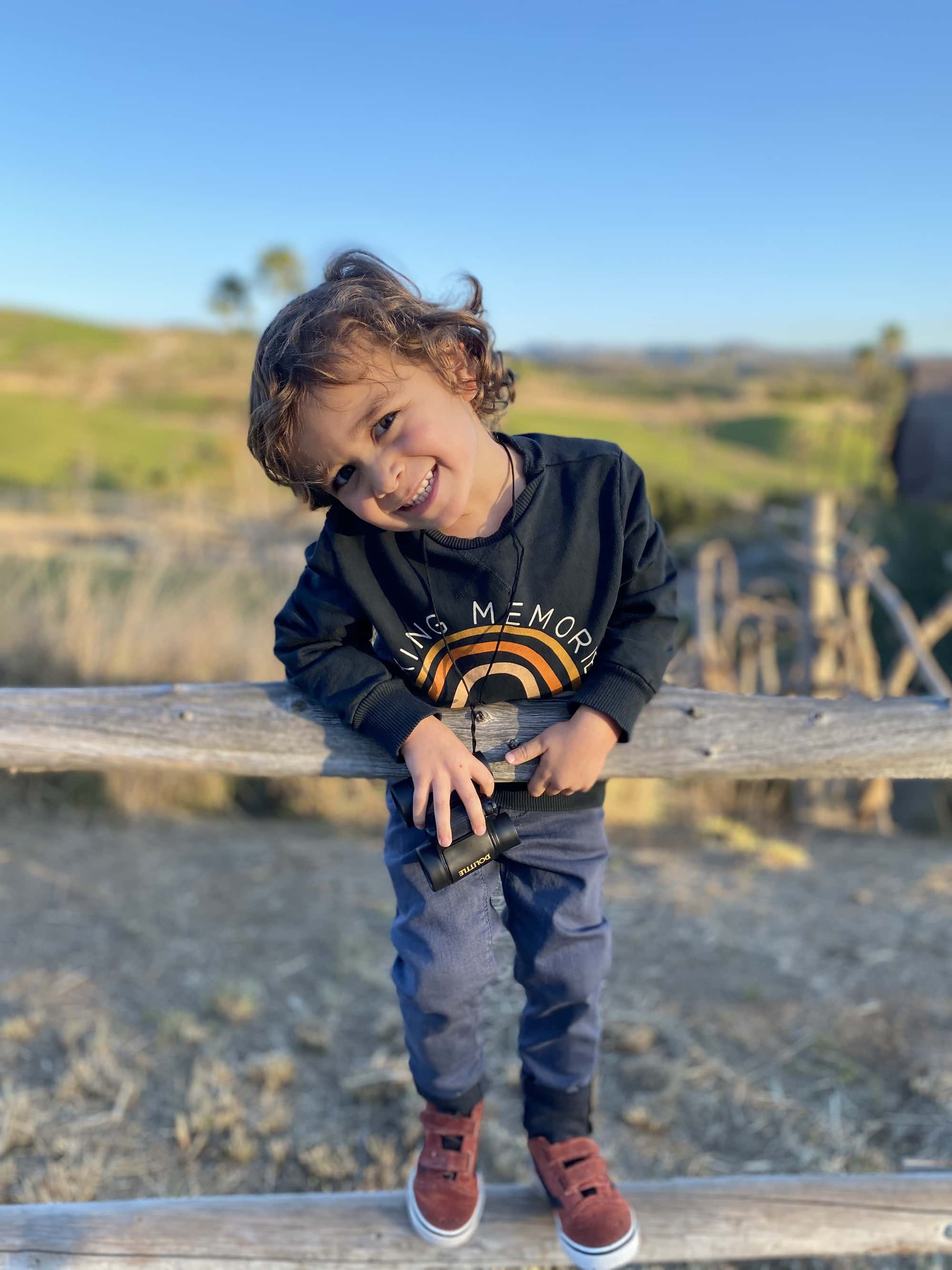 boy playing outside smiling