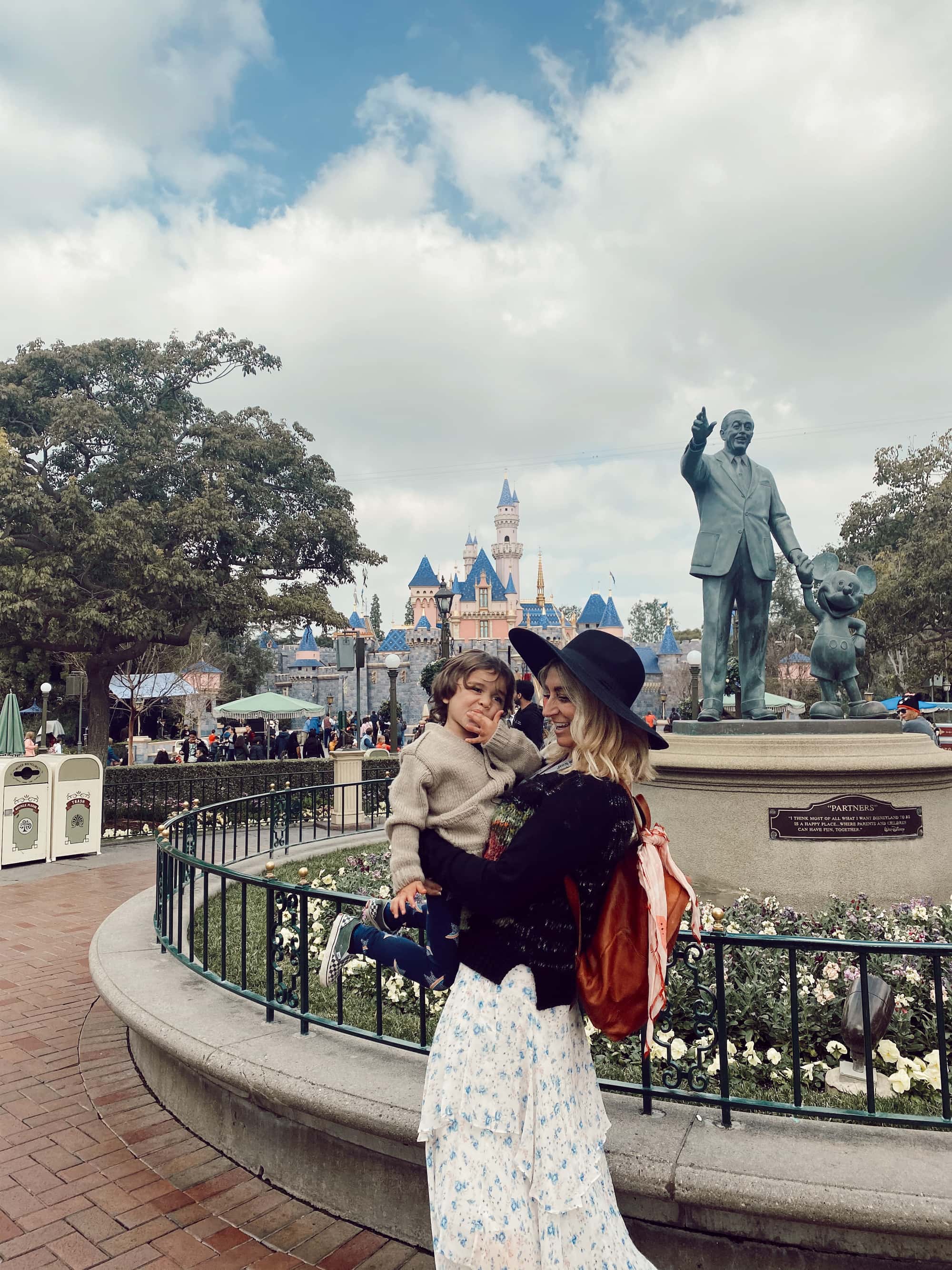 mother holding son at disneyland